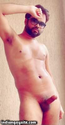Naked hunky model posing with a big hard boner