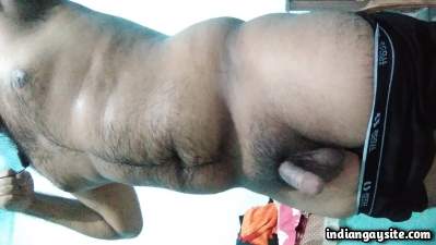 Hairy beefy man teasing his sexy body and hard dick